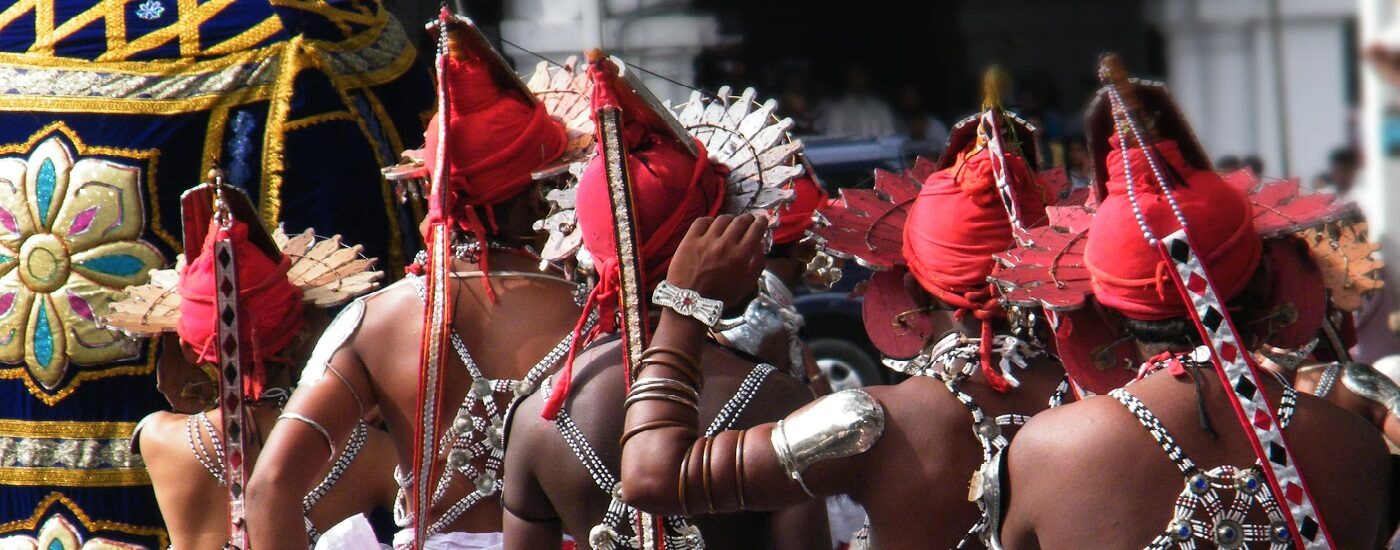 https://www.authenticindiatours.com/app/uploads/2023/07/Sri-Lankan-procession-Kandy-1400-1400x550-c-default.jpg