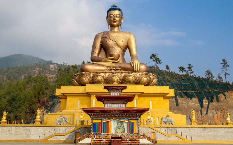 Customs and traditions in Bhutan - Buddha Dordenma Statue or Big Golden Buddha, in Thimphu. Large golden statue of Buddha sitting atop a temple.