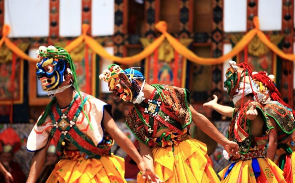 Customs and Traditions in Bhutan - Three Masked dancers at a festival in Mongar, Bhutan