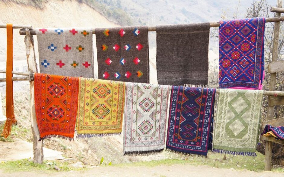 Customs and traditions in Bhutan - Image of colourful and patterned textiles hanging to dry on a washing line